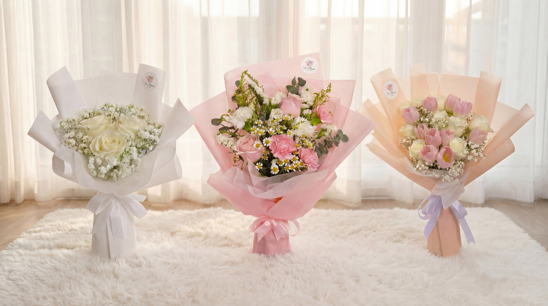 Three Fu Bloom flower bouquets side by side on a white fluffy rug in Singapore — white roses with baby's breath, pink roses with carnations, and a lily bouquet with purple wrapping