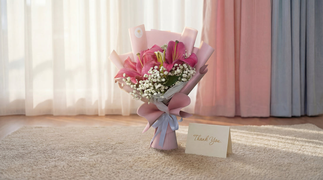 Pink lily bouquet with baby's breath and thank you card on carpet in Singapore studio